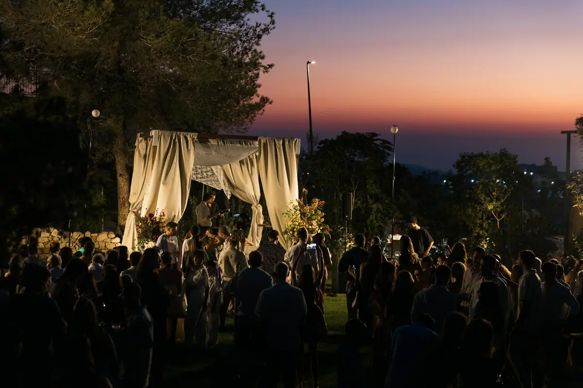 Guests around the chuppah at sunset