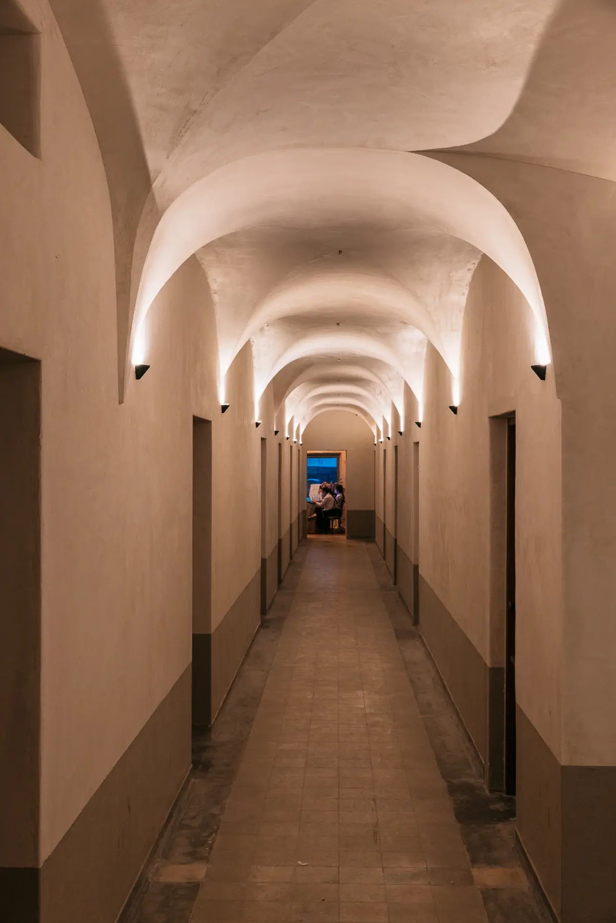 The vaulted corridor of the rooms wing
